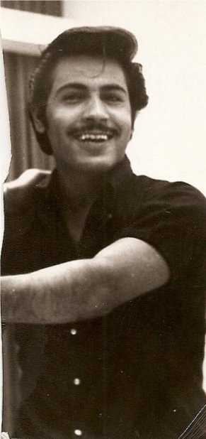 الوسيم سعد الفريح صاحب الابتسامة الجميلة يرتدي قميصًا داكنًا وذراعه مرفوعة.